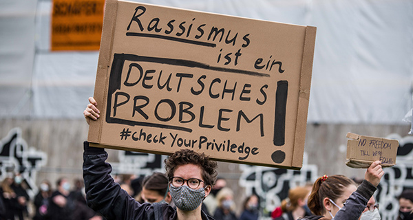 독일의 한 여성이 인종차별 피켓을 들고 있다